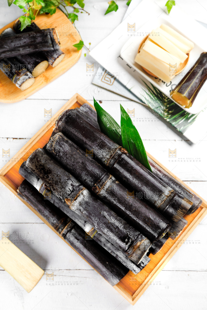 白底上木盘里的新鲜黑皮甘蔗