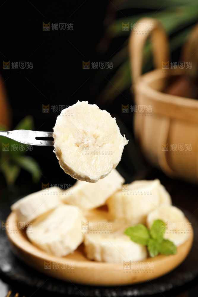 黑底上叉子叉着一块红皮香蕉果肉