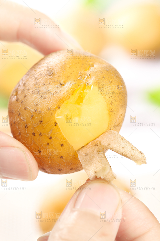 手拿剥皮的熟土豆