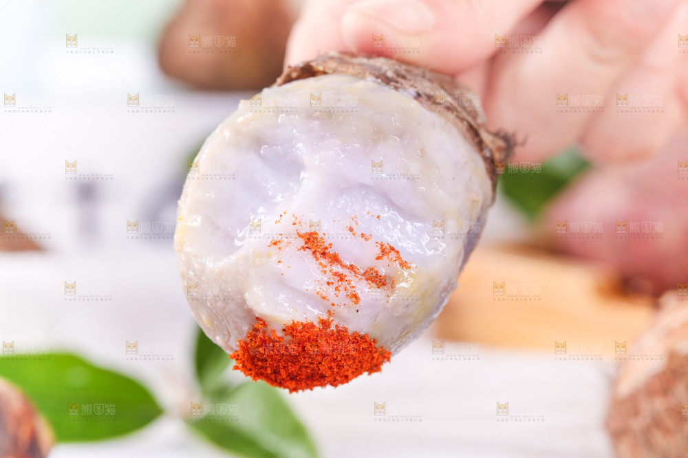 手拿蘸辣椒的香芋