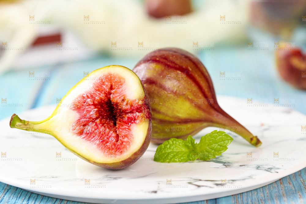 盘子里放着掰开的紫皮无花果