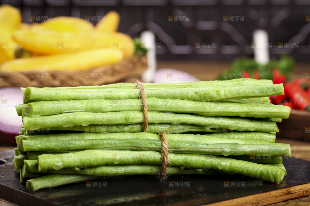 木板上放着一盘新鲜豆角
