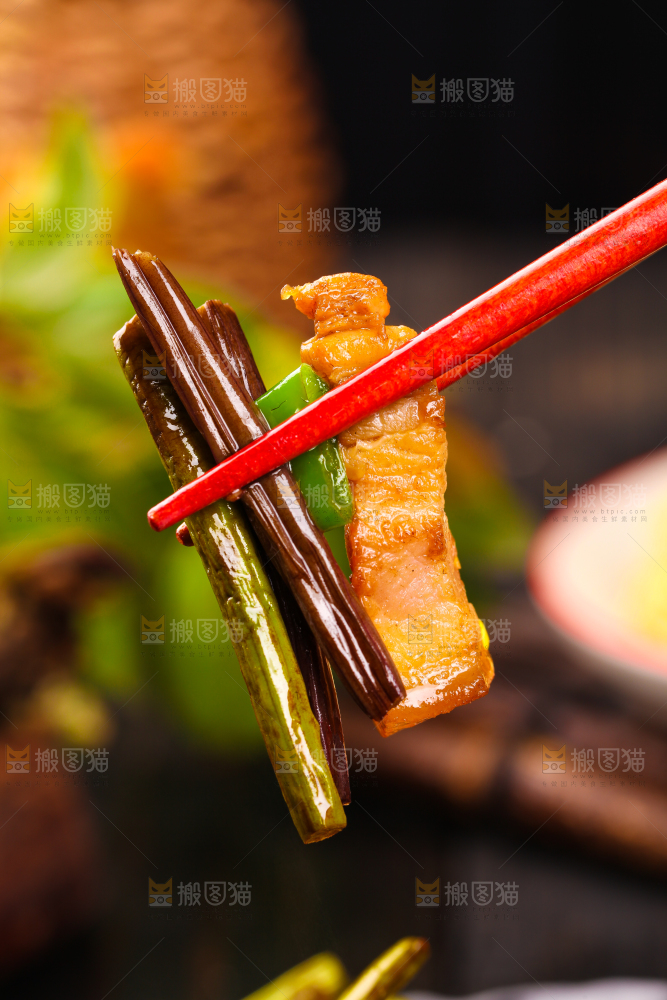 筷子夹着蕨菜炒肉