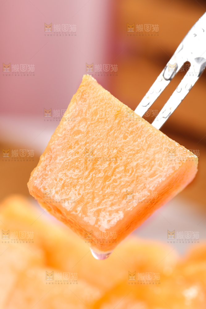 叉子叉着一块新鲜哈密瓜