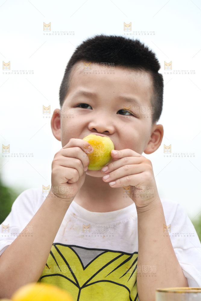 小男孩正在吃李子