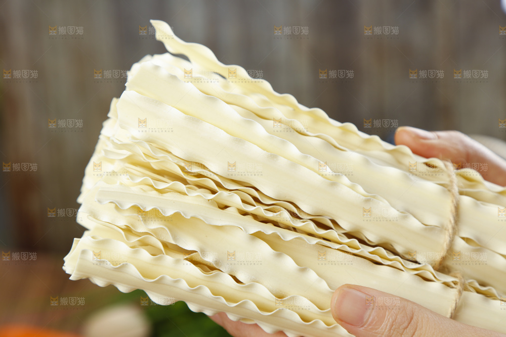 手上拿着手工刀削面
