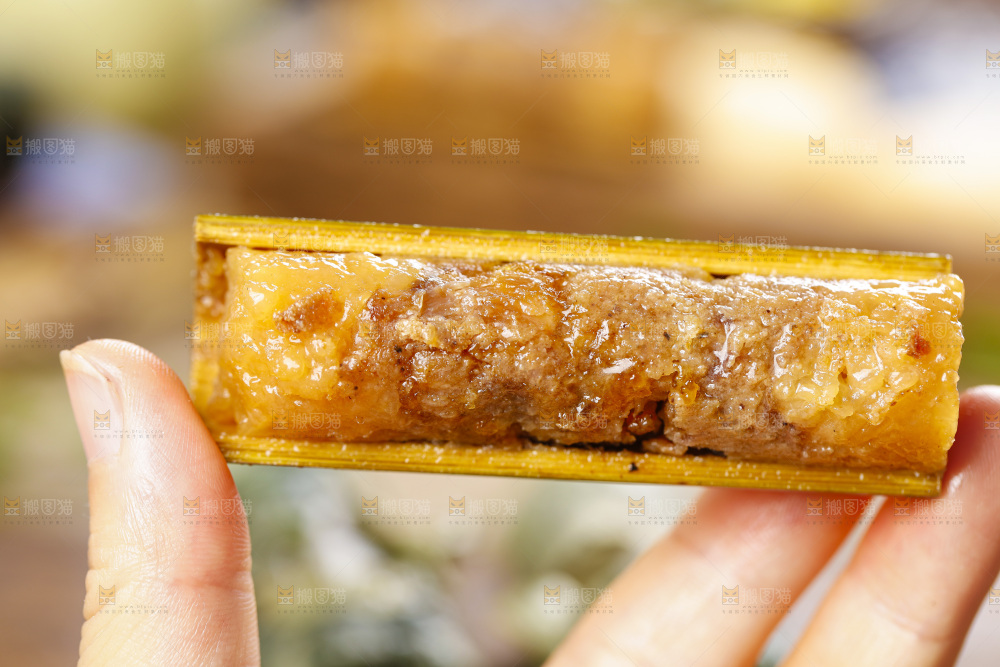 手里拿着竹筒糯米饭