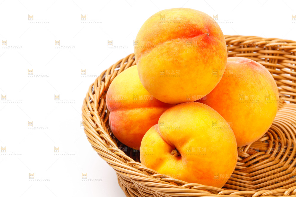 白底上放着一筐新鲜黄桃