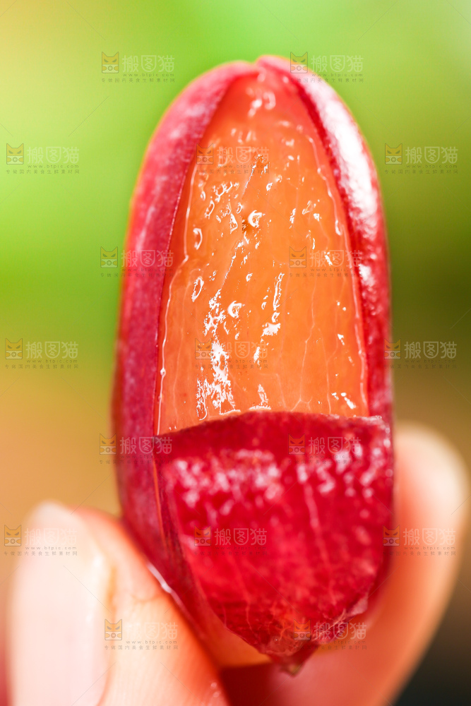 手里拿着剥皮的美人指葡萄