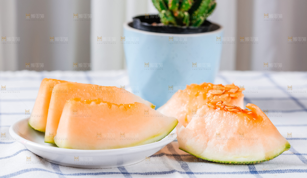 格子布上放着新鲜哈密瓜