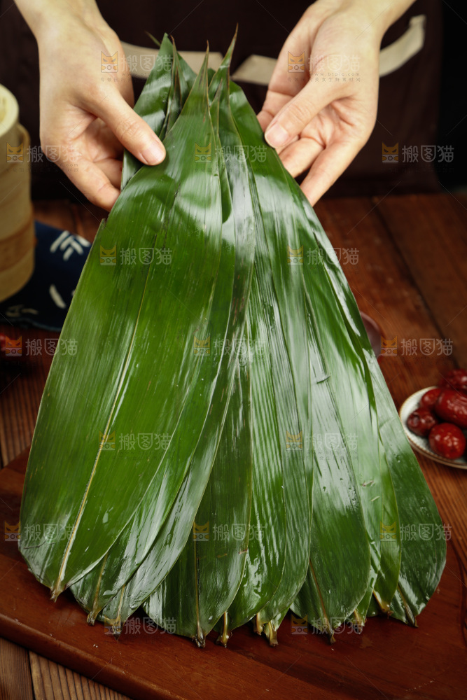 手里拿着天然粽子叶