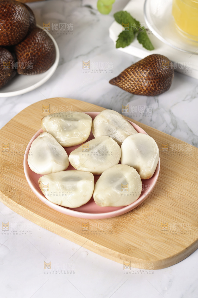 木板上放着一盘蛇皮果果肉