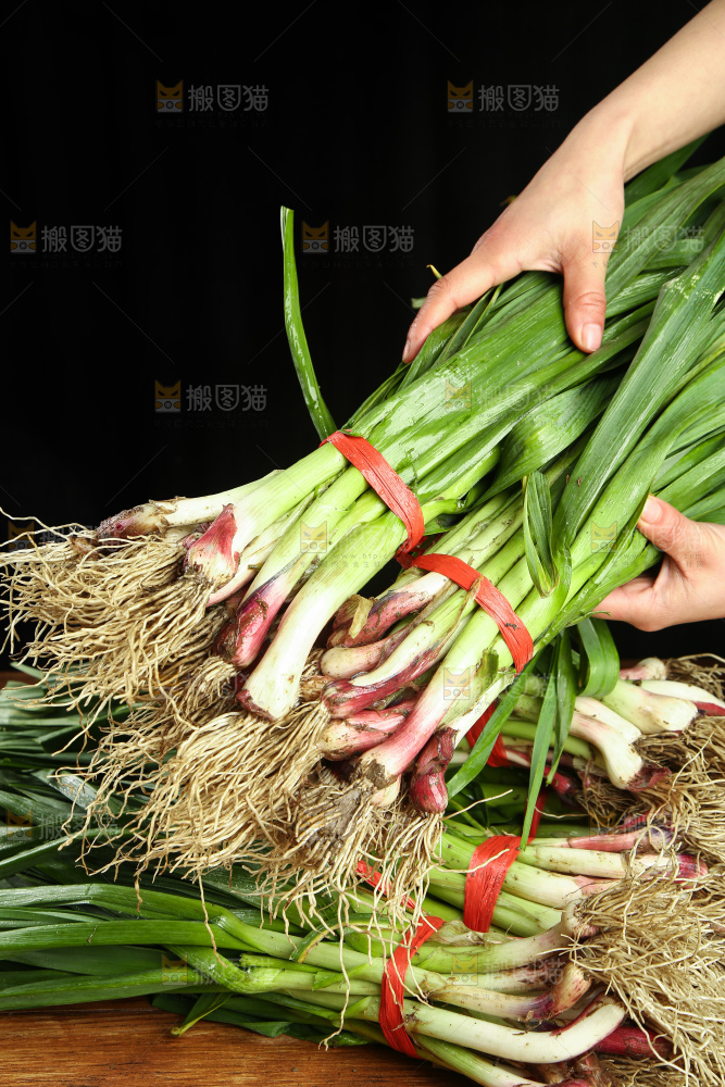 手上拿着蒜苗