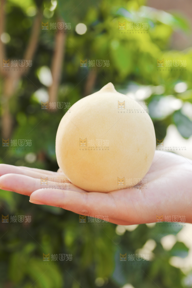 手上拿着奶油大白桃