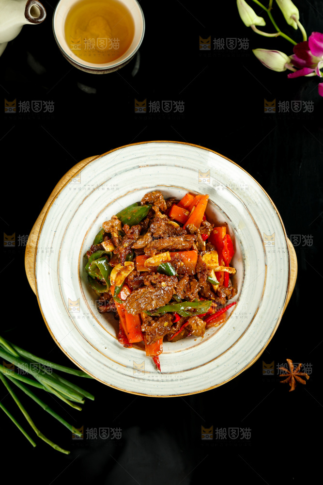 木板上放着一盘青椒烧牛肉