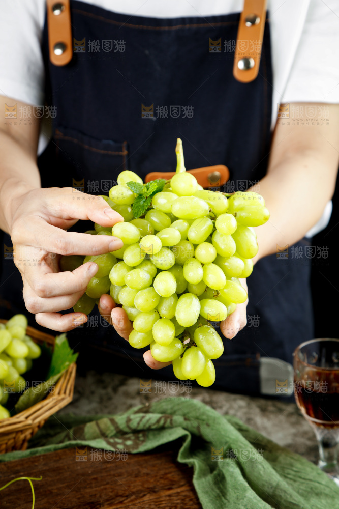 手里拿着白葡萄