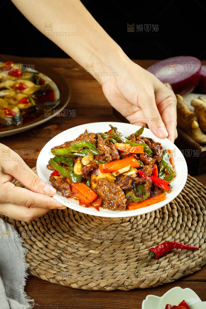 手里端着一盘辣椒炒牛肉