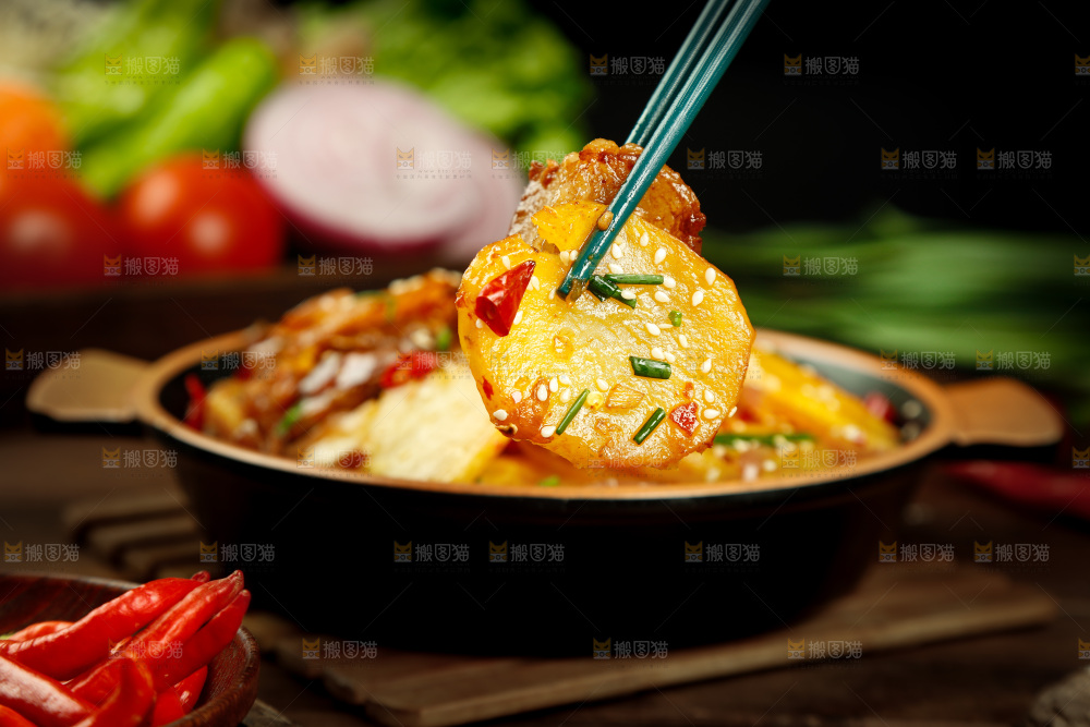 筷子上夹着香辣土豆片