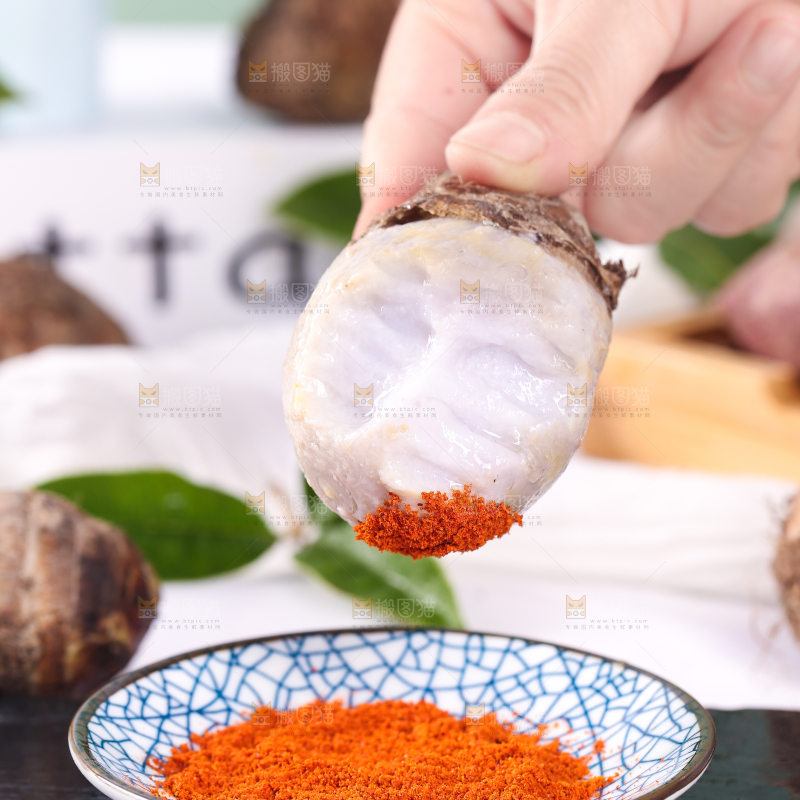 手拿蘸辣椒的香芋
