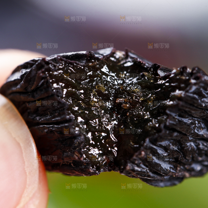 手里拿着黑葡萄干