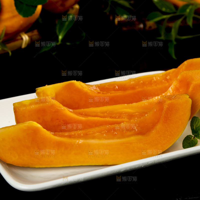 黑底上放着新鲜的海南红心木瓜