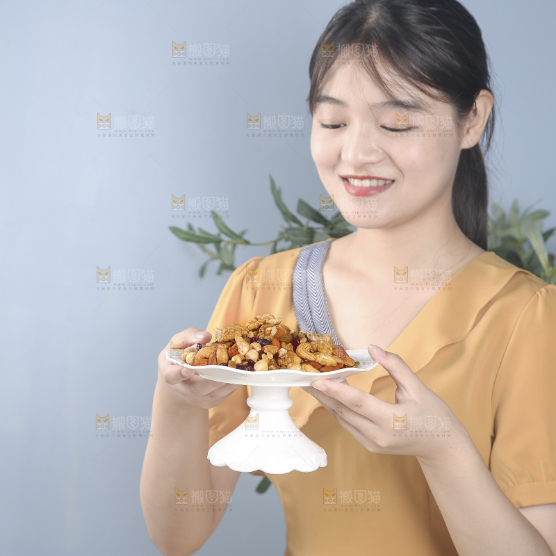 女孩手上端着一盘坚果组合