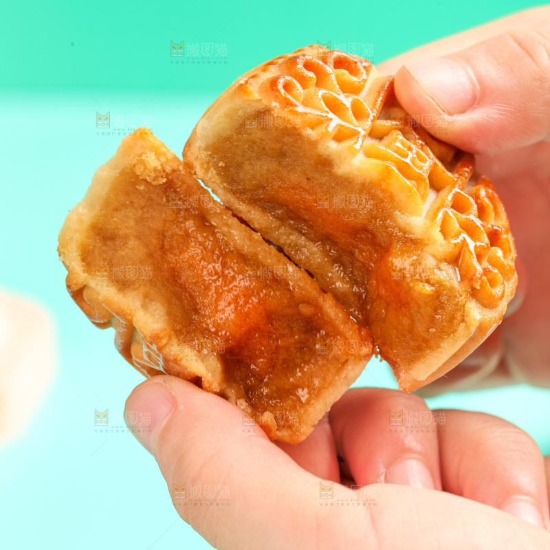 手拿着掰开的蛋黄月饼