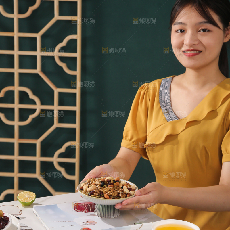 女孩端着一盘坚果组合