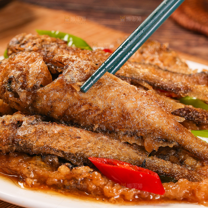 筷子上夹着香酥煎鱼