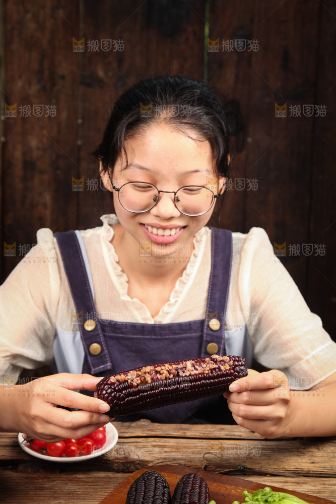 手里拿着黑玉米
